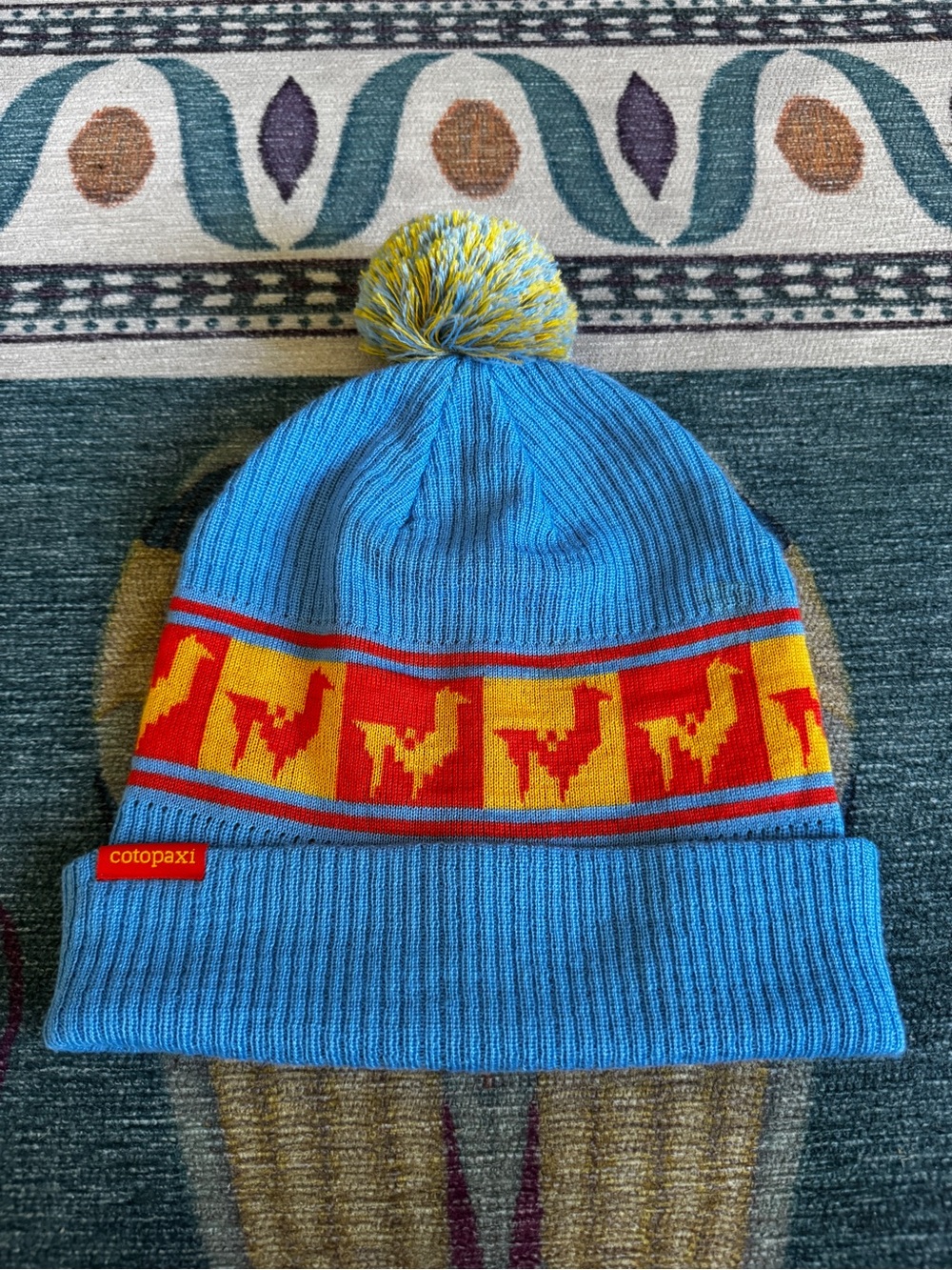 Cotopaxi • Blue Pom Llama Beanie with Yellow & Red Accent